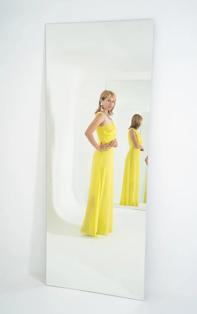 woman, mirror, reflection, recursion, long dress, yellow dress, evening dress, fashion, style, watch, full length, model, pose, bright, yellow, sight, in full growth, fitting, dressing room, mirror, mirror, mirror, mirror, mirror, recursion, recursion, recursion, yellow dress, yellow dress, yellow dress, yellow dress, yellow dress, dressing room. Identifying a shopper problem a smart fitting room can solve